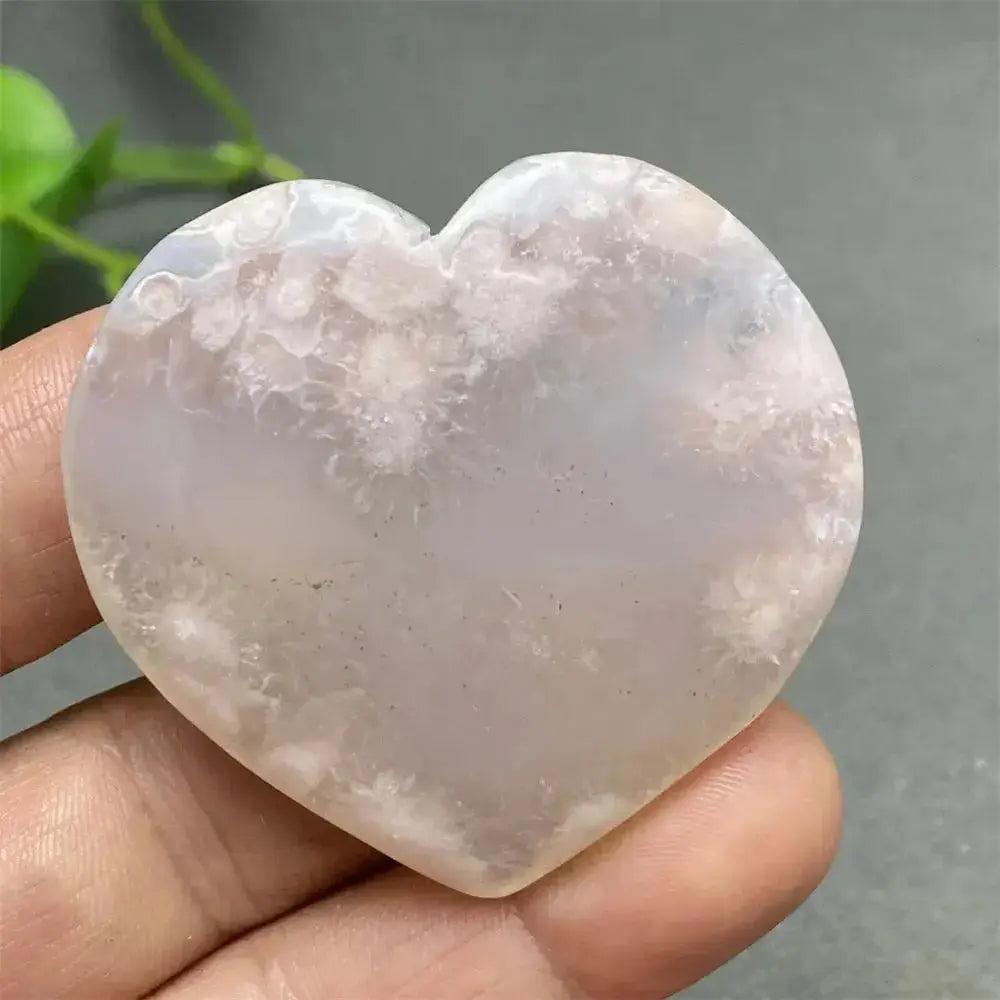 Cherry Blossom Agate Heart: Polished pink and white crystal heart with unique floral-like inclusions, promoting self-love.
