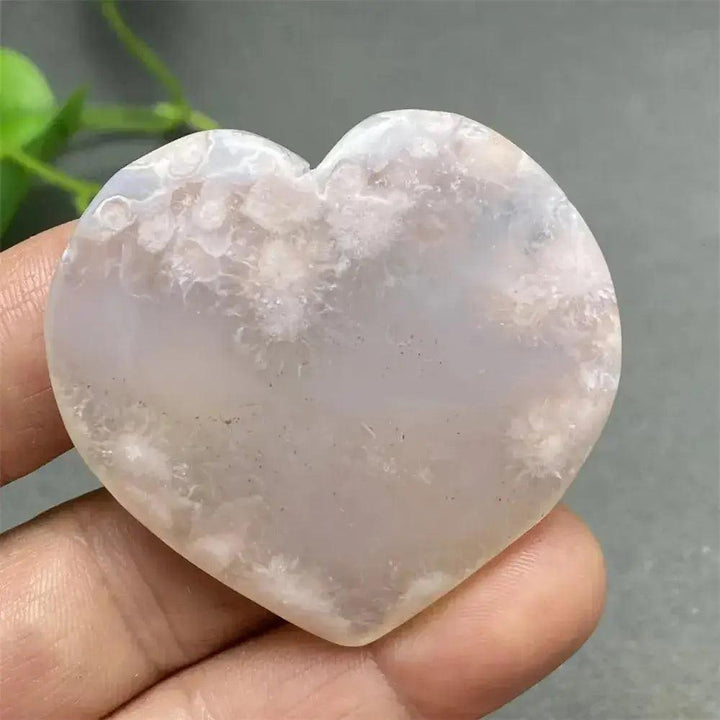 Cherry Blossom Agate Heart: Polished pink and white crystal heart with unique floral-like inclusions, promoting self-love.