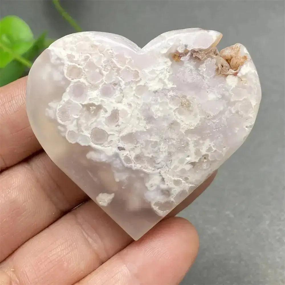 Cherry Blossom Agate Heart: Polished pink and white agate heart with unique floral inclusions, promoting self-love.
