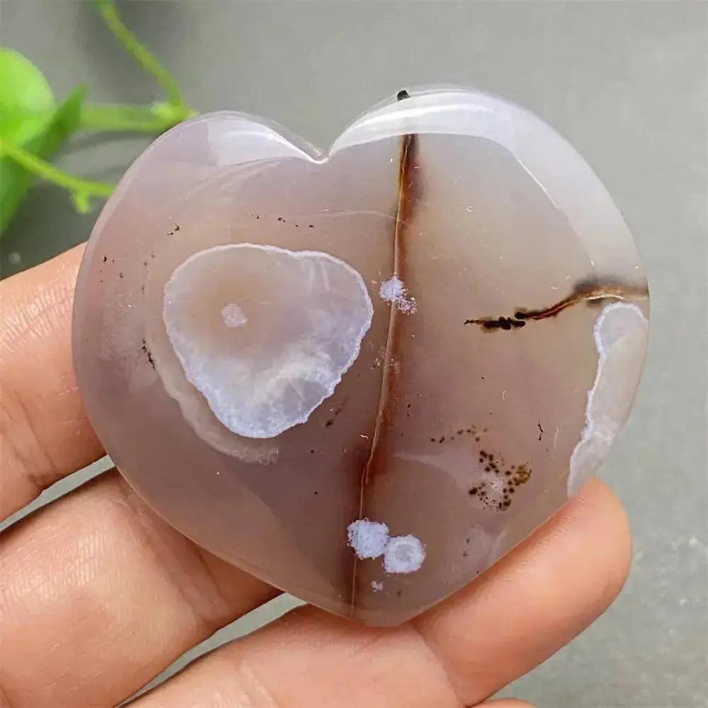 Polished Cherry Blossom Agate Heart with delicate pink and white floral patterns, promoting emotional healing and self-love.