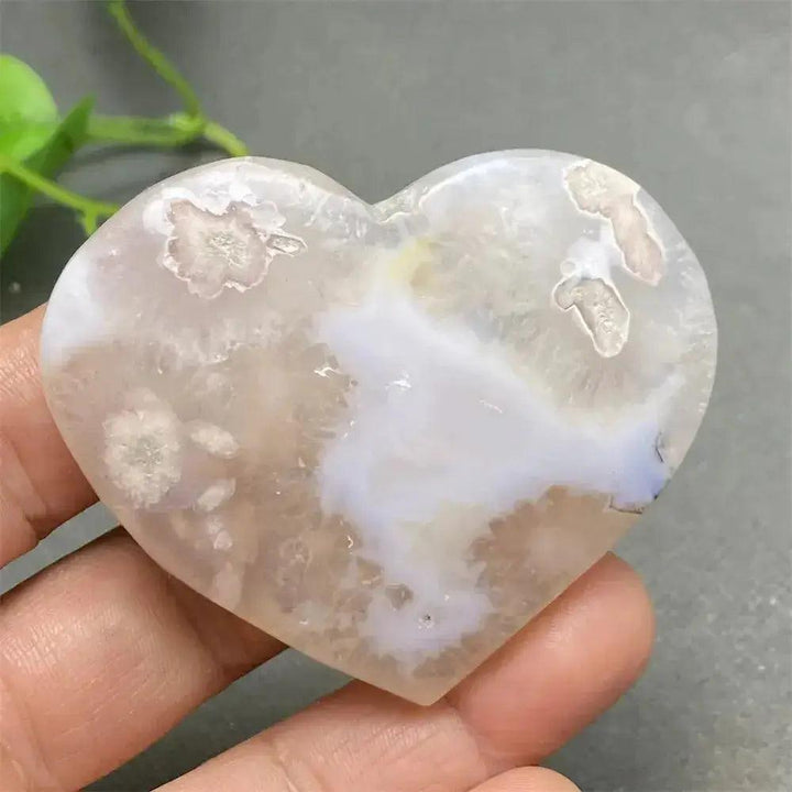 Polished Cherry Blossom Agate Heart with delicate pink and white floral patterns, promoting emotional healing and self-love.
