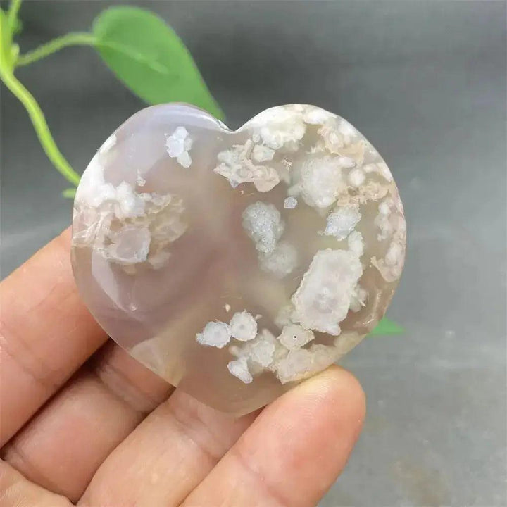 Cherry Blossom Agate Heart: Polished pink and white heart-shaped crystal, promoting emotional healing and self-love.