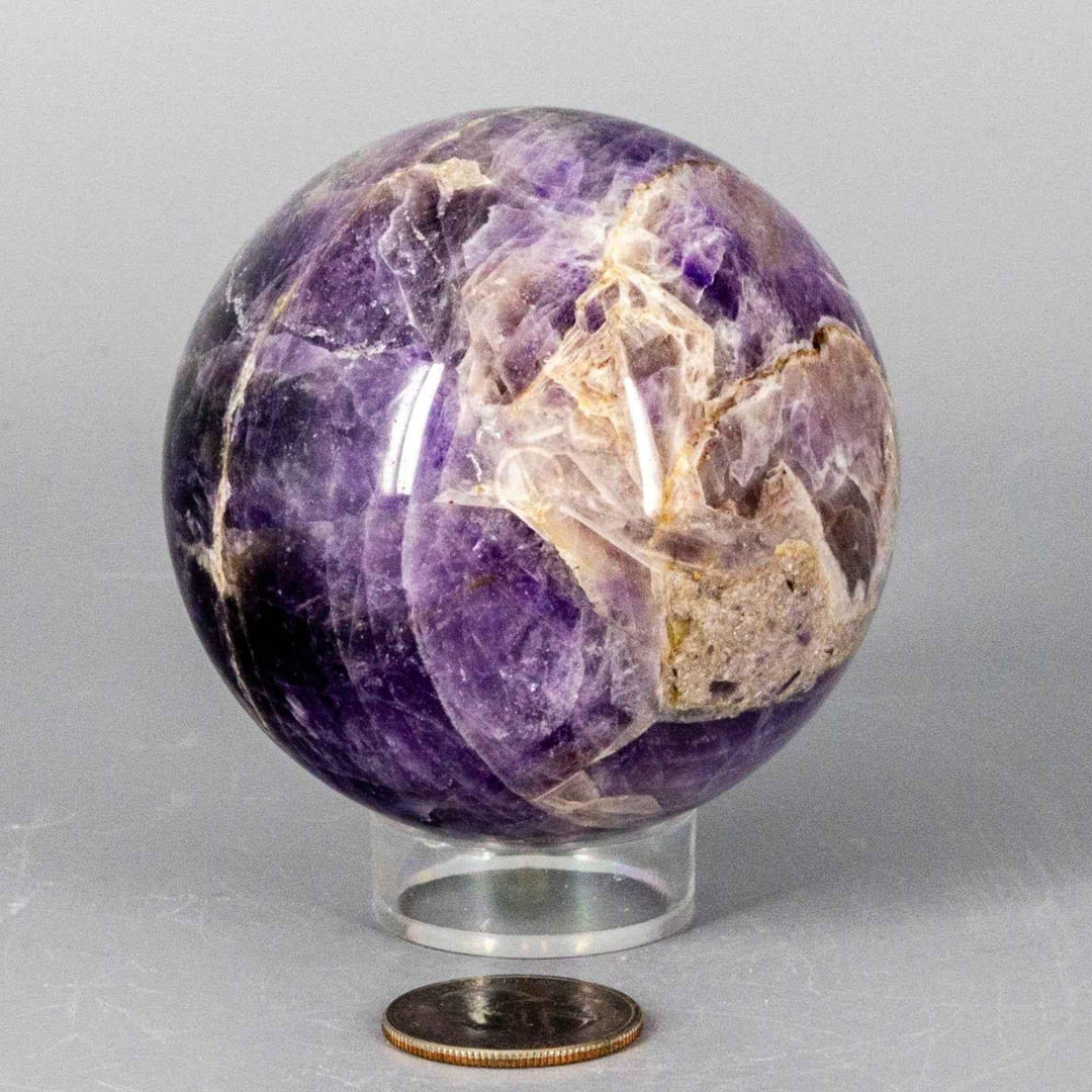 Chevron Amethyst Sphere, 58-71MM, with deep violet and white V-shaped banding, radiating combined energy.