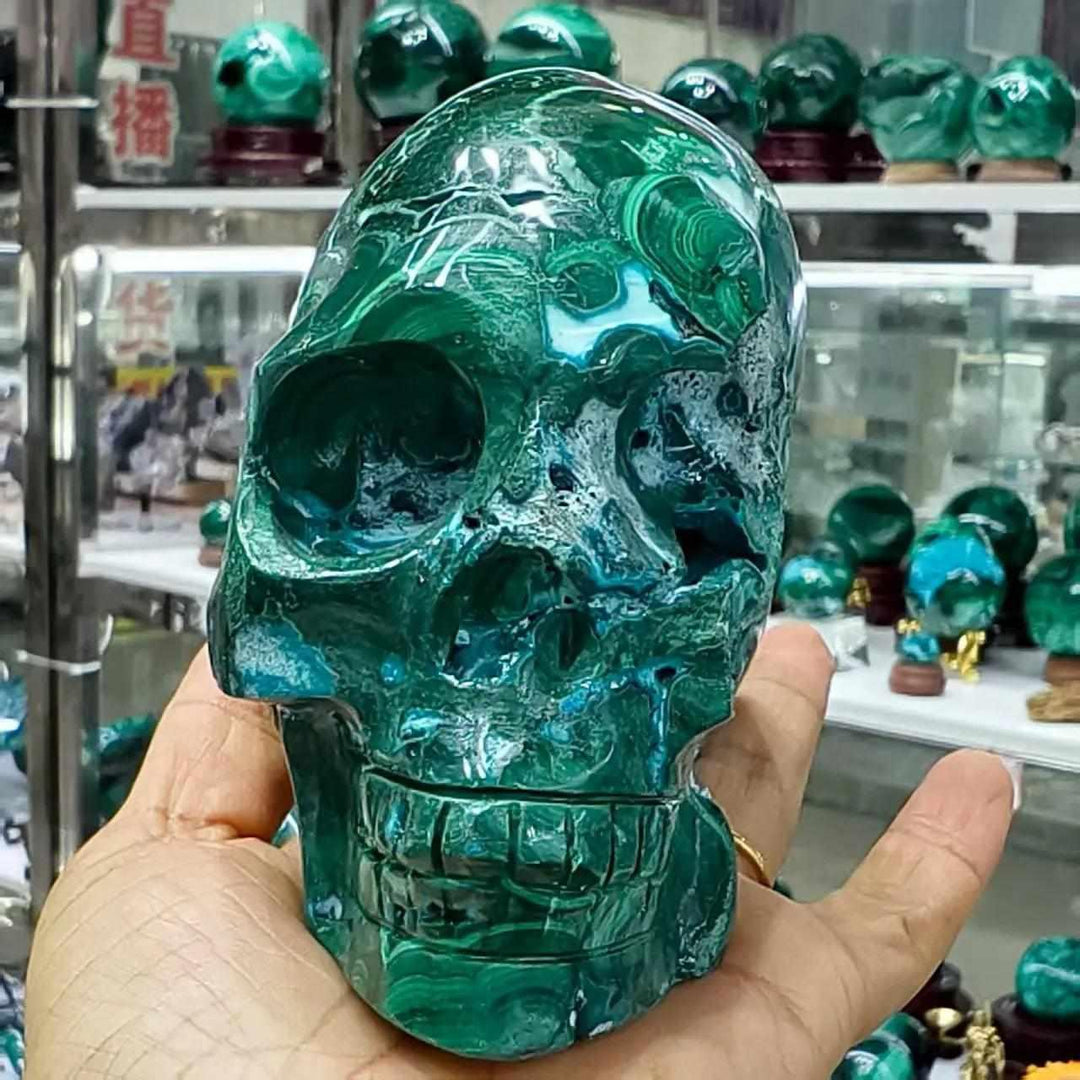Hand-carved Chrysocolla Quartz skull featuring vibrant green and blue patterns, perfect for Throat and Heart Chakra healing.