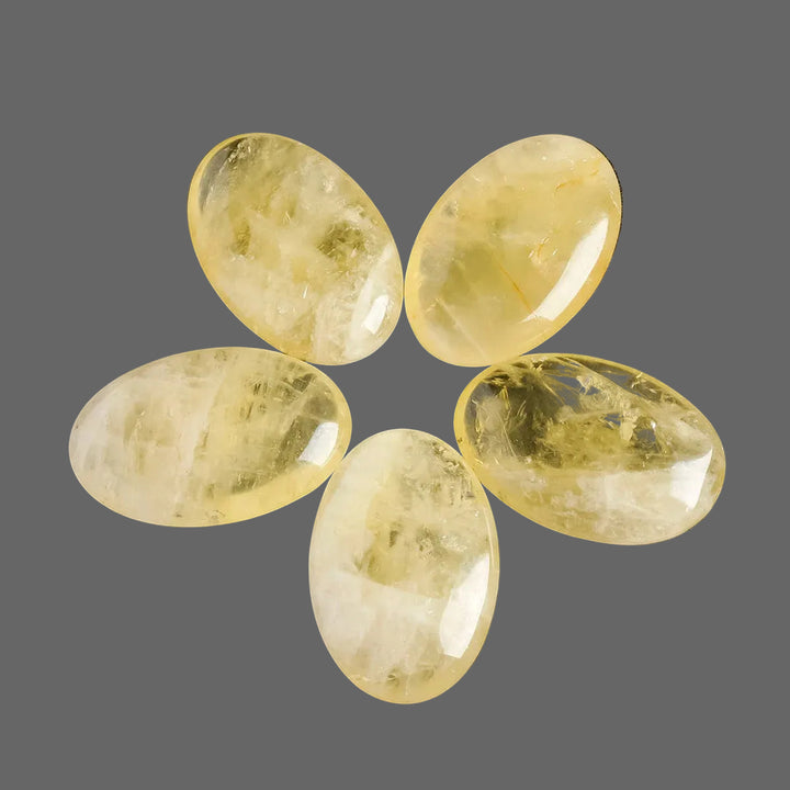 Polished natural citrine palm stone for Reiki healing, featuring a smooth, golden yellow quartz design for energy balancing.