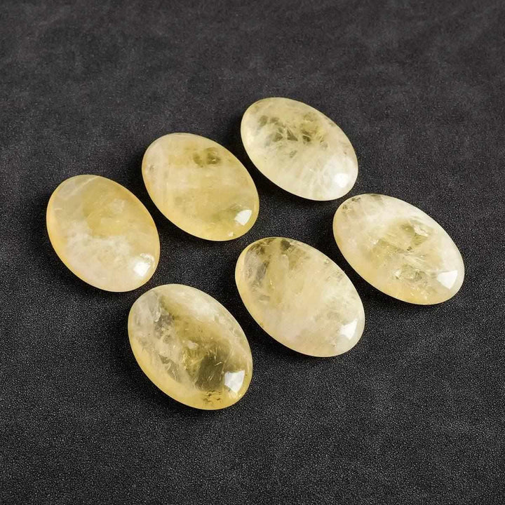 Polished natural citrine palm stones, smooth oval yellow quartz crystals for Reiki energy healing and home decor.