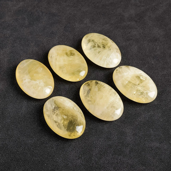 Polished natural citrine palm stones, smooth oval yellow quartz crystals for Reiki energy healing and home decor.