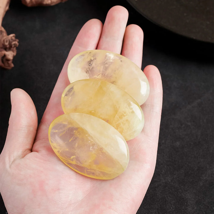 Three polished natural citrine palm stones with golden hues, perfect for Reiki healing and calming energy meditation.