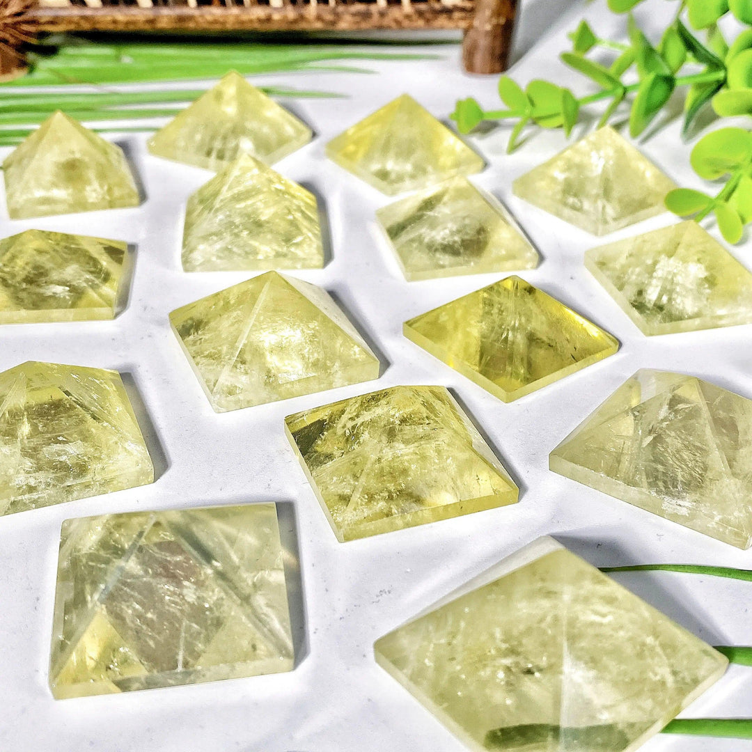 Natural citrine crystal pyramids featuring a vibrant yellow hue and polished finish for healing and home decor.