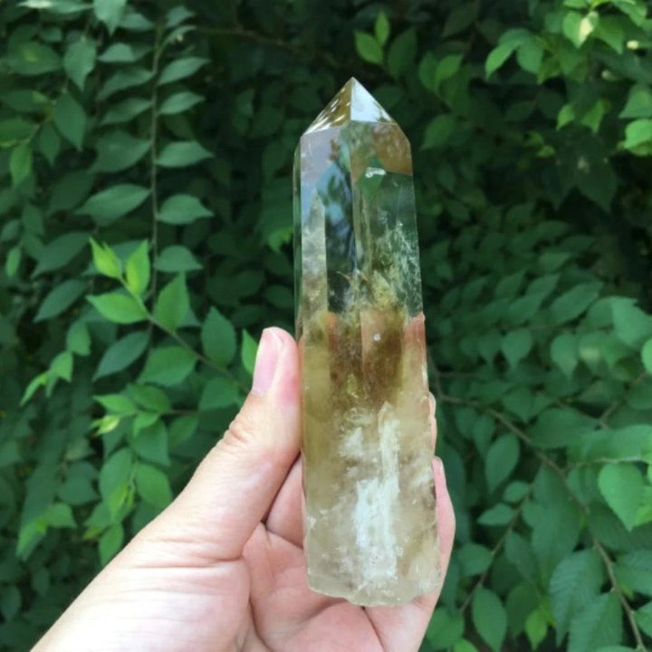 Handheld Citrine Quartz raw crystal point with golden hues and natural inclusions for manifestation and vitality.
