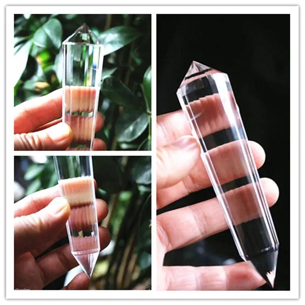 Clear Quartz 24 Faceted Vogel Wand by Crystal Destiny, held in hand, showing its transparent clarity and pointed ends.
