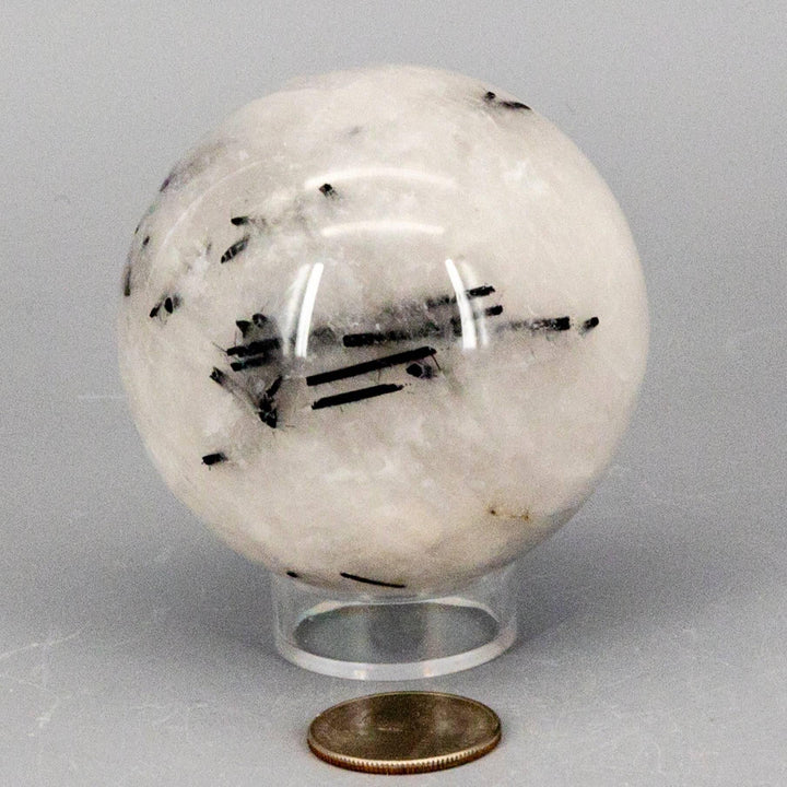 Quartz w/t Black Tourmaline Inclusions 68MM sphere, clear with bold black formations, amplifying and protective.