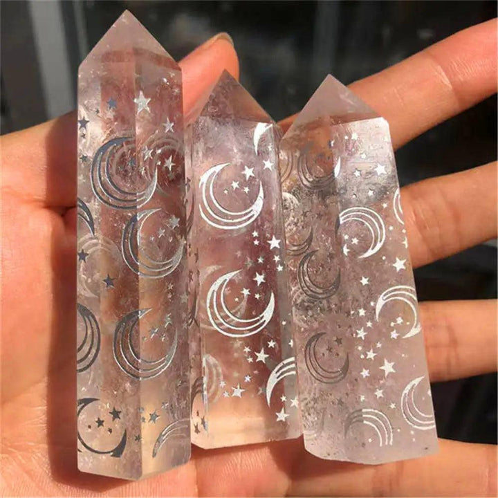 Natural clear quartz crystal tower wands featuring etched moon and star designs for spiritual healing and energy.