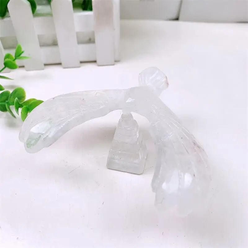 Hand-carved clear quartz eagle spinning on a pyramid base, a powerful crystal sculpture for manifestation and energy.