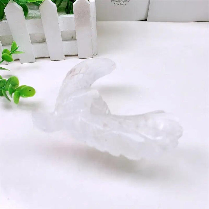 Hand-carved clear quartz spinning eagle on pyramid statue for manifestation, featuring a balanced, translucent design.