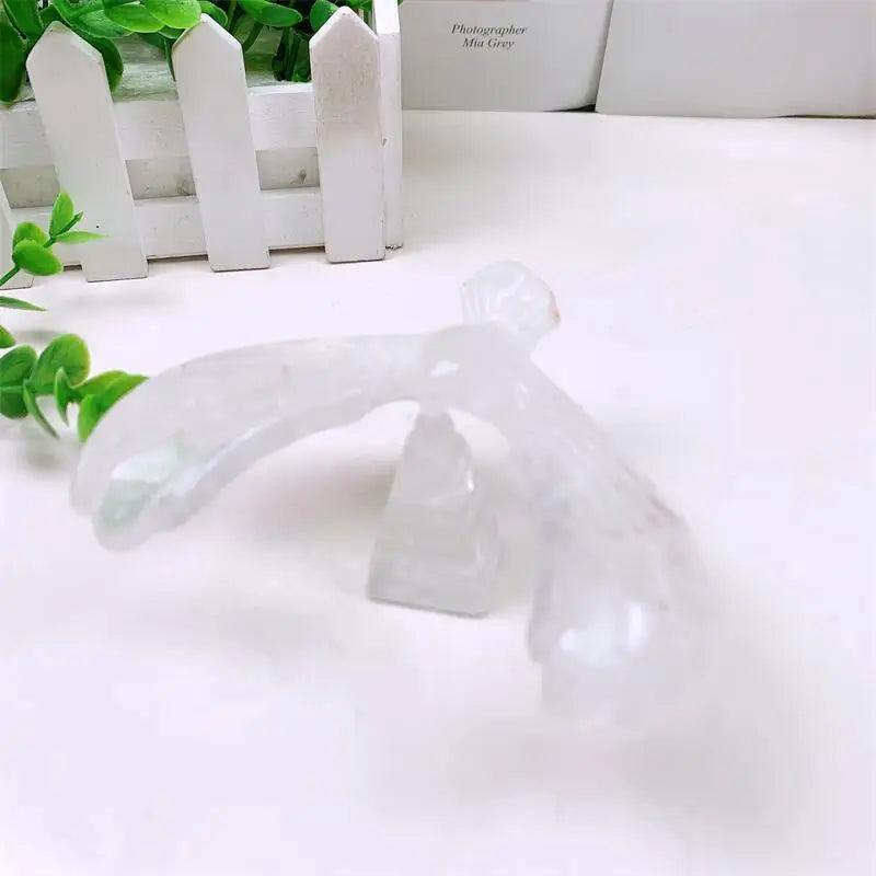 Clear quartz crystal eagle statue carved to spin on a pyramid base, symbolizing vision and amplified energy.
