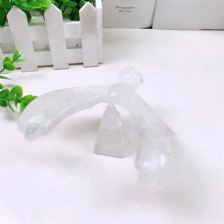 Clear quartz crystal eagle statue carved to spin on a pyramid base, symbolizing vision and amplified energy.