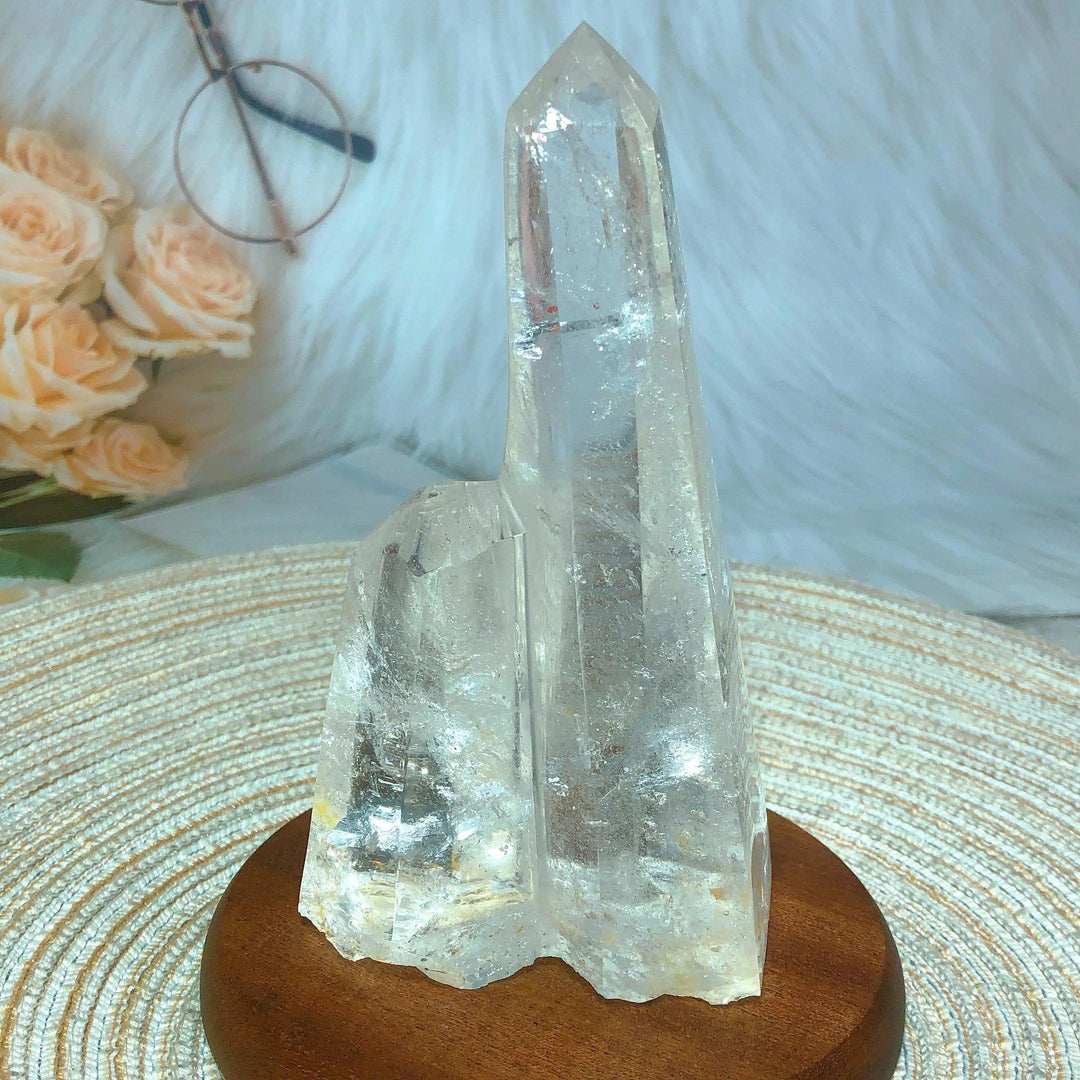 Clear Quartz double mountain tower, raw and unpolished, on a wooden base, for healing and manifestation.