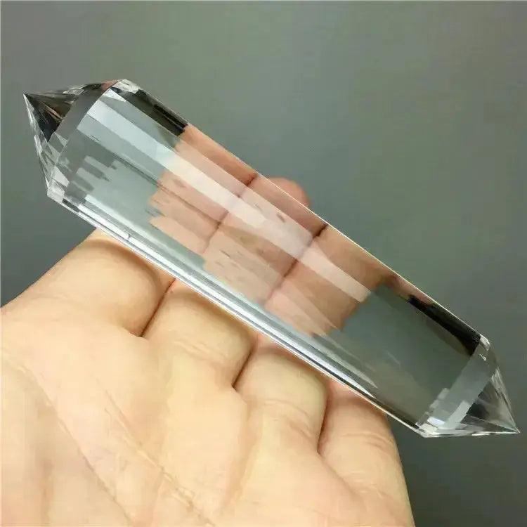 Clear Quartz Crystal Double Terminated Vogel Healing Wand, held in hand, showcasing its precision cut and clarity.