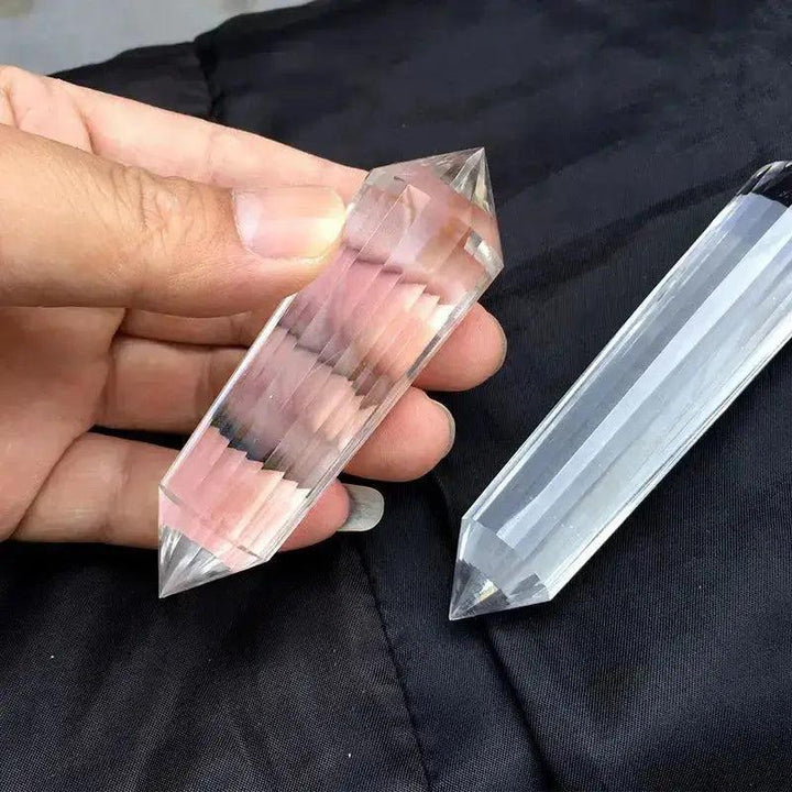 Clear Quartz Crystal Double Terminated Vogel Healing Wand, held by hand, showcasing its faceted, transparent design.