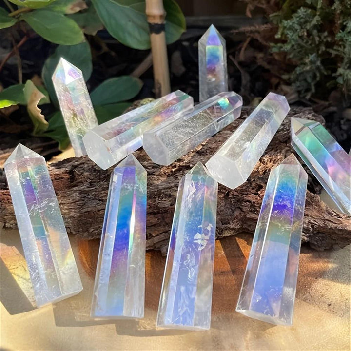 Iridescent electroplated clear quartz crystal stone towers with healing aura glow.