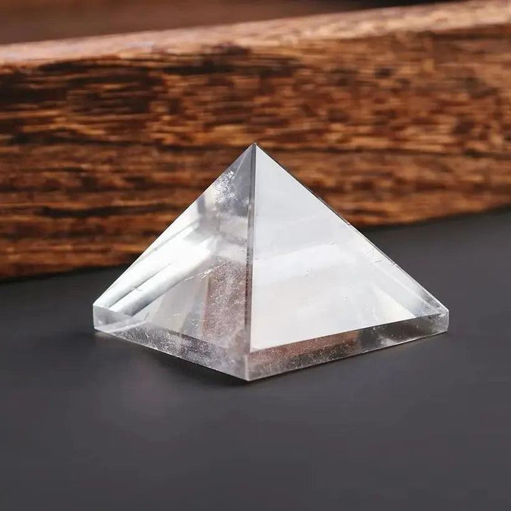 Natural clear quartz crystal pyramid for chakra healing and meditation, with a pointed tower design.