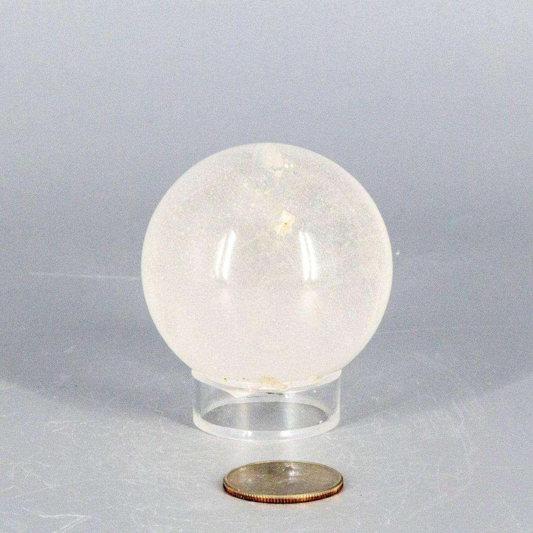 Natural Clear Quartz Sphere Master Healer, 53-55mm, polished to a glassy clarity on a clear stand.
