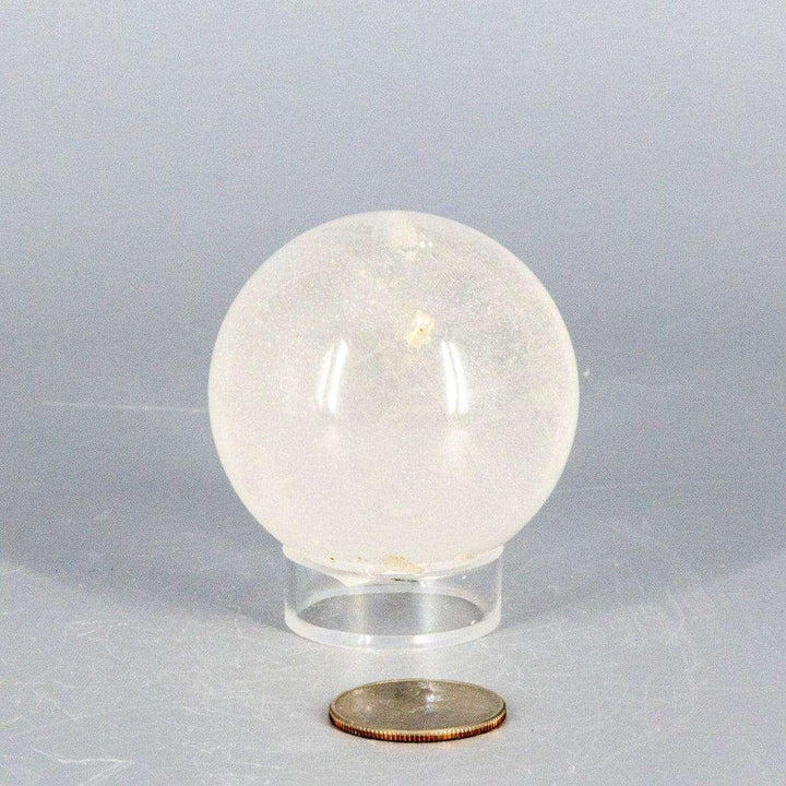 Natural Clear Quartz Sphere Master Healer, 53-55mm, polished to a glassy clarity on a clear stand.