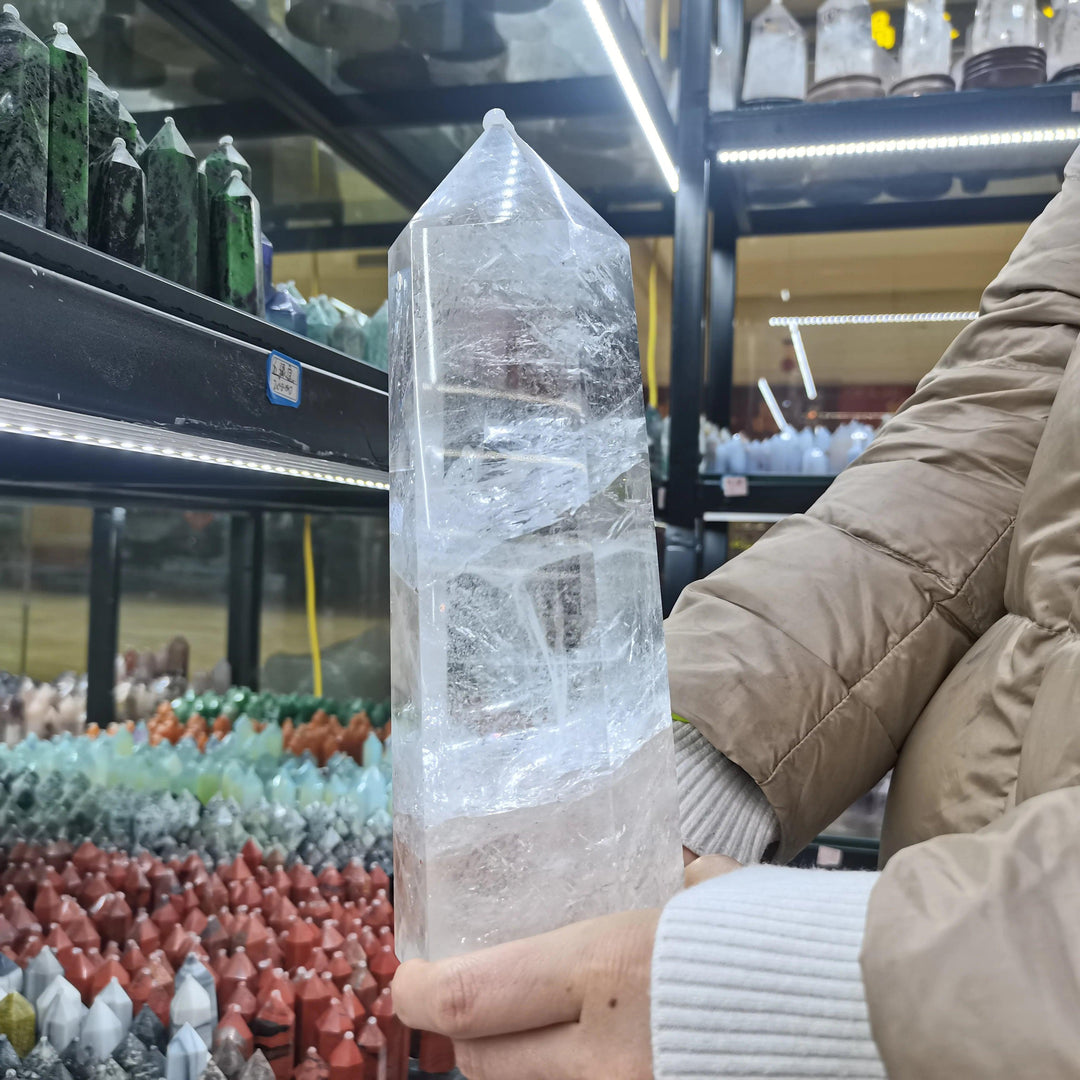 Large, polished clear quartz crystal tower obelisk, amplifying healing and manifestation.