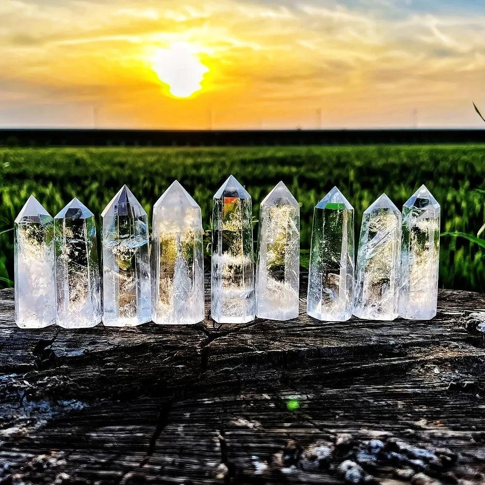 Clear quartz hexagonal obelisk wands with natural transparency, perfect for healing, meditation, and home decor display.