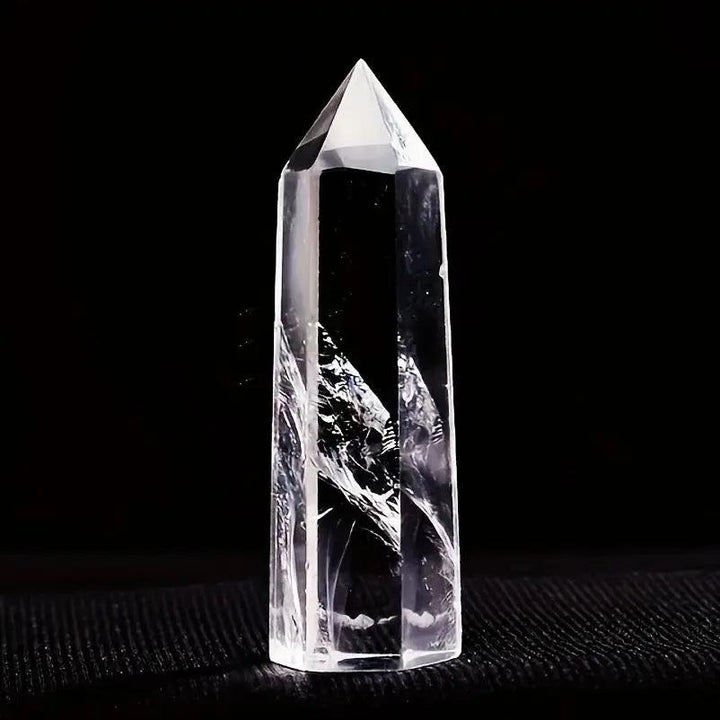 Natural clear quartz crystal hexagonal obelisk wand, a transparent healing stone point for home decor and energy balancing.