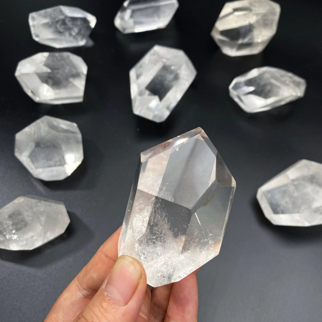 Handheld natural clear quartz freeform crystal with a polished, transparent finish for healing and home decor.