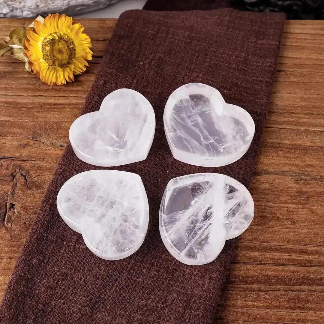 Four polished clear quartz heart bowls, 50-60mm, perfect for crystal storage and Crown Chakra energy amplification.