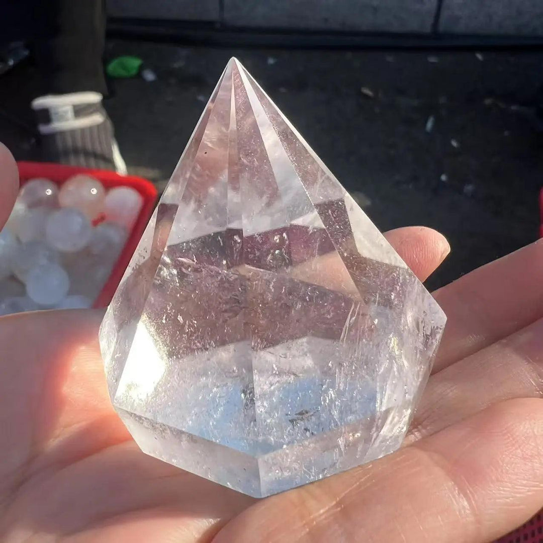 Clear natural quartz crystal pyramid, hexagonal gemstone for Reiki healing.