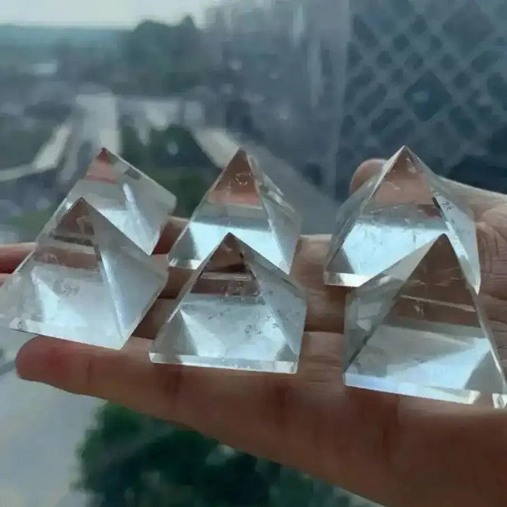 Hand-polished Clear Quartz mini pyramids with natural inclusions, perfect for amplifying intention and Crown chakra healing.