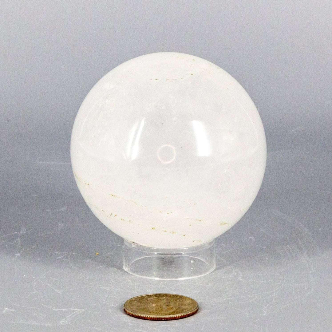 Clear Quartz Sphere 67mm: Polished, substantial, and holdable, radiating energy with natural inclusions.