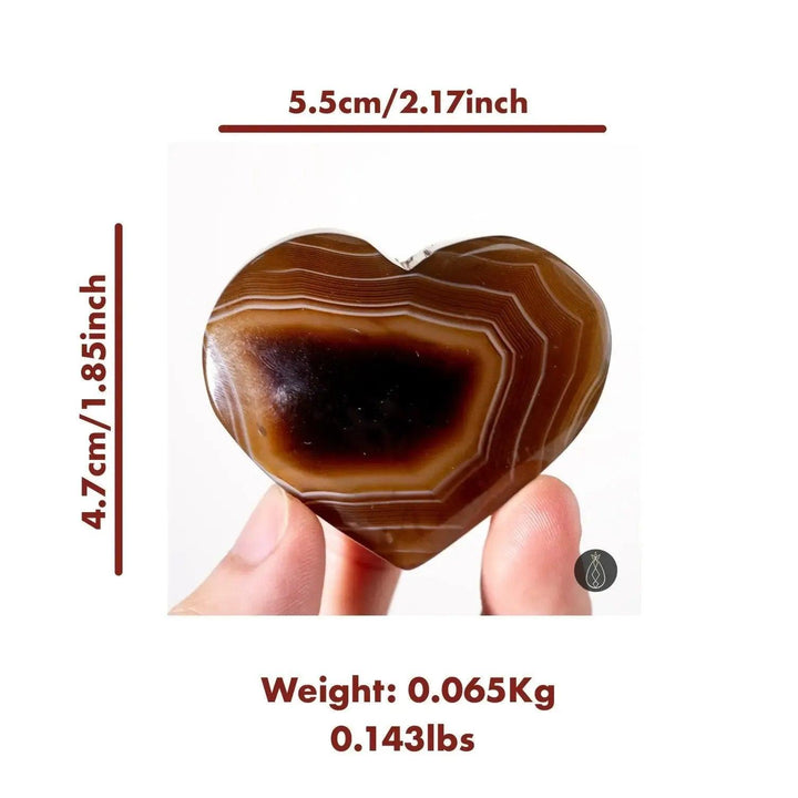 Polished coffee agate crystal heart with caramel, chocolate, and cream bands, promoting grounding energy from Crystal Destiny.