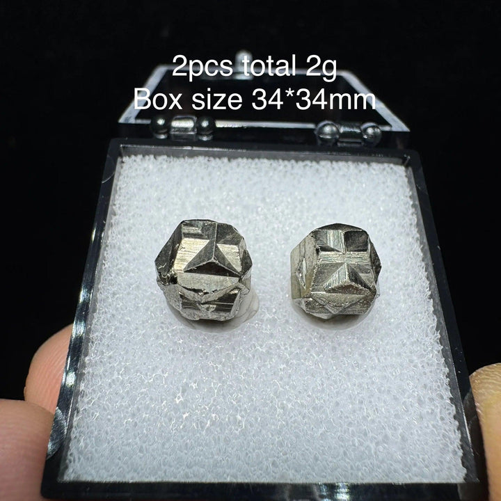 Two raw Colombia cross pyrite crystals with metallic luster in a 34x34mm display box, perfect for healing and home decor.