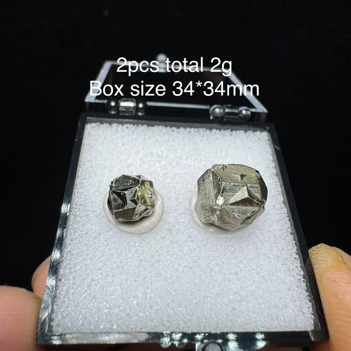Two raw Colombia Cross Pyrite crystals with metallic luster in a 34x34mm display box, perfect for healing and home decor.
