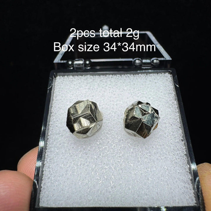 Two natural Colombia cross pyrite crystals in a 34x34mm display box, featuring metallic gold luster for healing and decor.