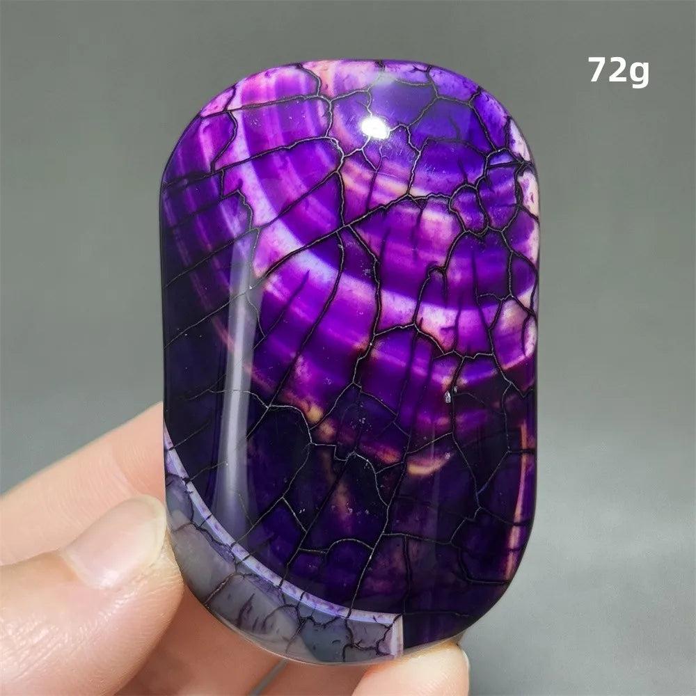 Polished purple dragon pattern agate palm stone, a 72g natural crystal for healing, meditation, and Feng Shui decor.