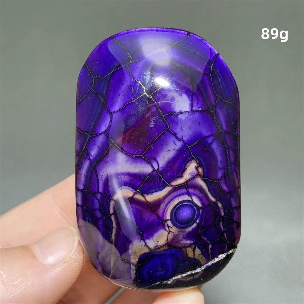 Polished 89g purple dragon pattern agate palm stone for healing, meditation, and beautiful Feng Shui home decor.