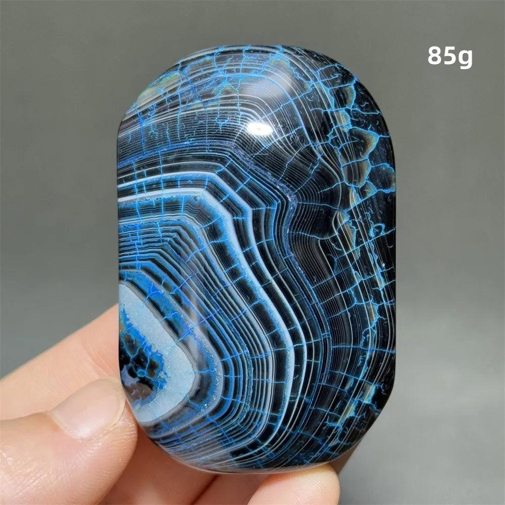85g polished blue and black dragon pattern agate palm stone for healing, meditation, and feng shui home decor.