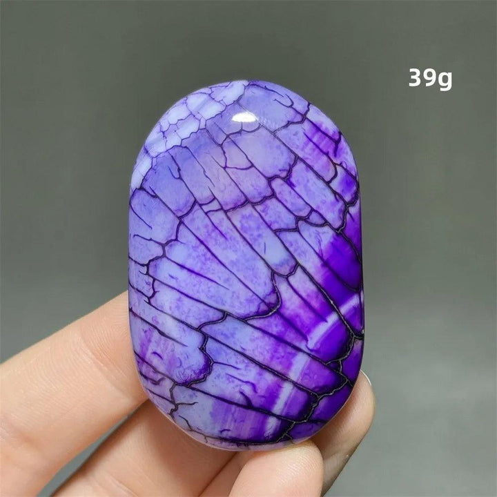 Polished purple dragon pattern agate palm stone, a 39g natural crystal for healing, meditation, and feng shui decor.