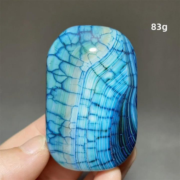 83g blue agate palm stone with a striking dragon pattern, perfect for healing, meditation, and feng shui home decor.