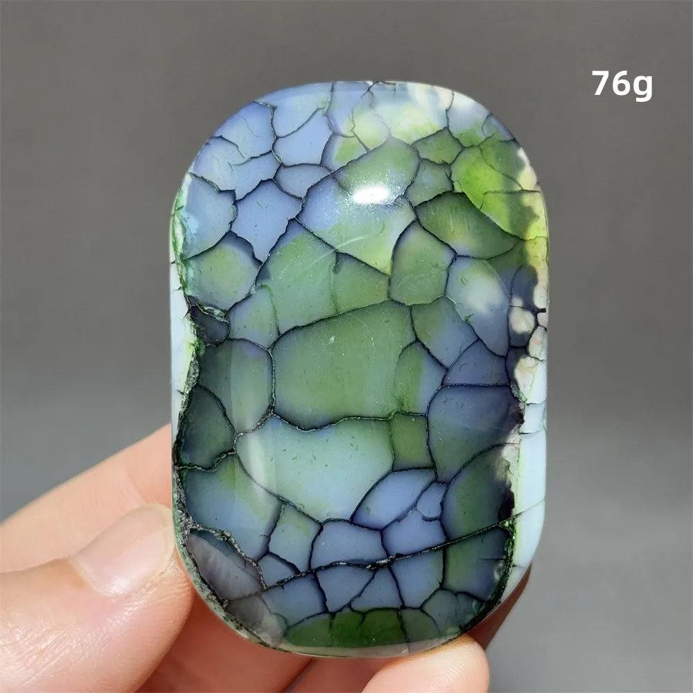 Polished 76g colorful dragon pattern agate palm stone with vibrant green and blue crackle textures for healing meditation.
