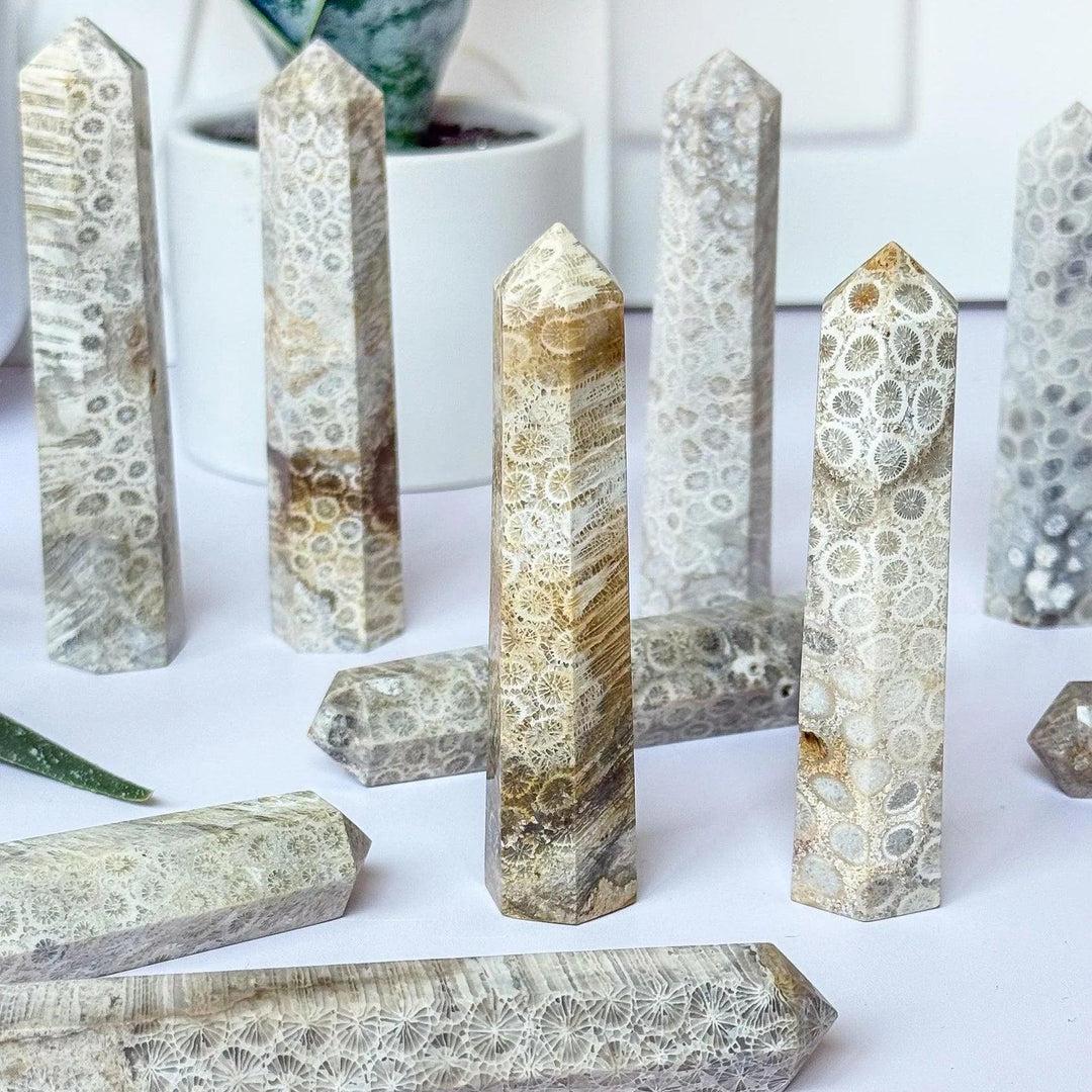 Natural coral jade pillar towers with unique fossil patterns, offering healing energy for home decor.