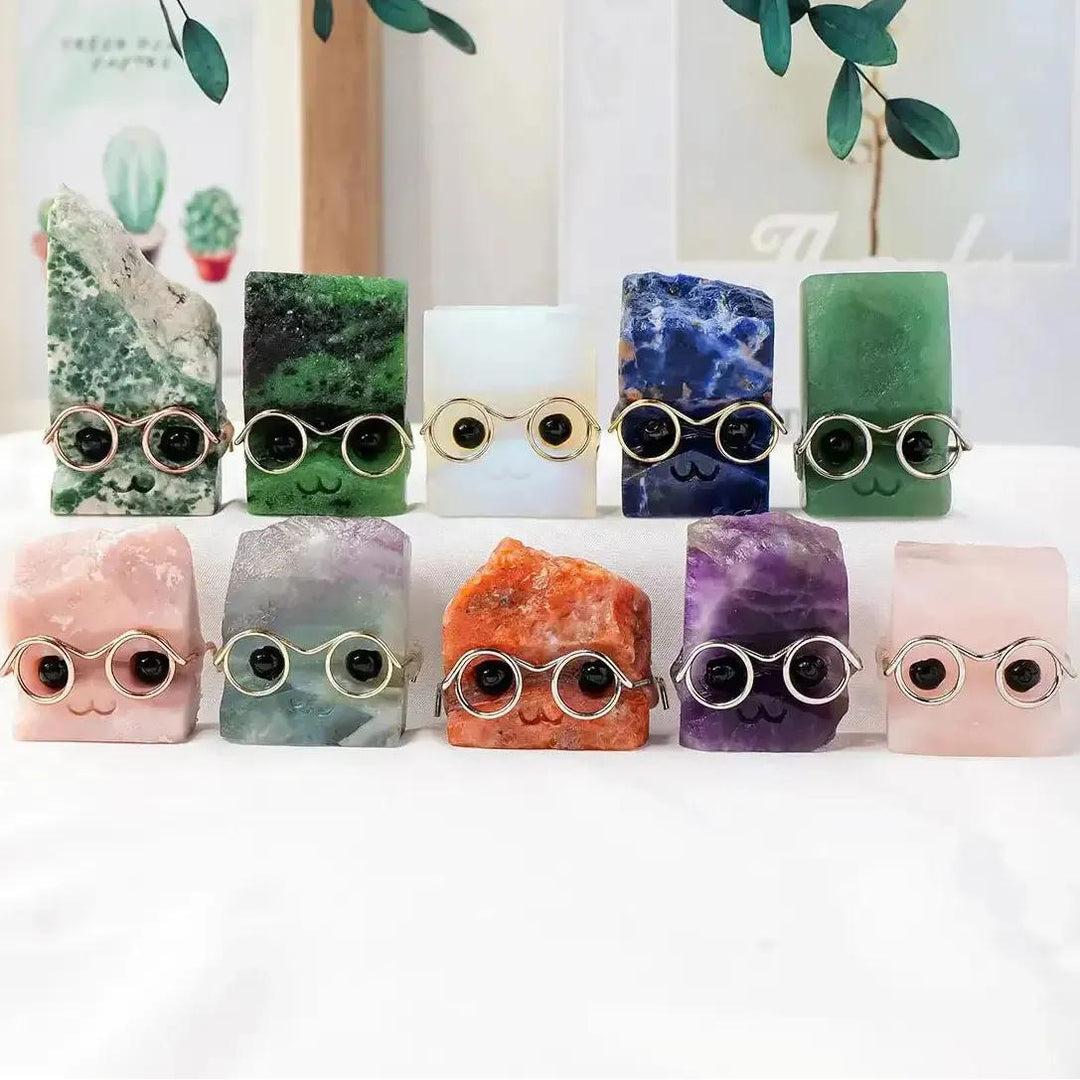 Crystal Destiny raw gemstone bookworms in various colors with gold wire glasses and carved faces.
