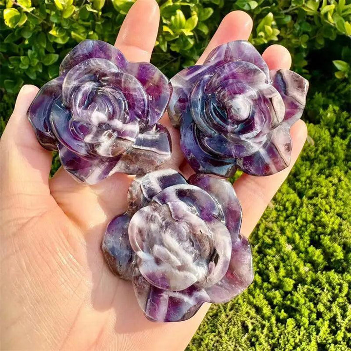 Three hand-carved amethyst flower figurines with dreamy violet hues, perfect for healing and heart chakra energy.