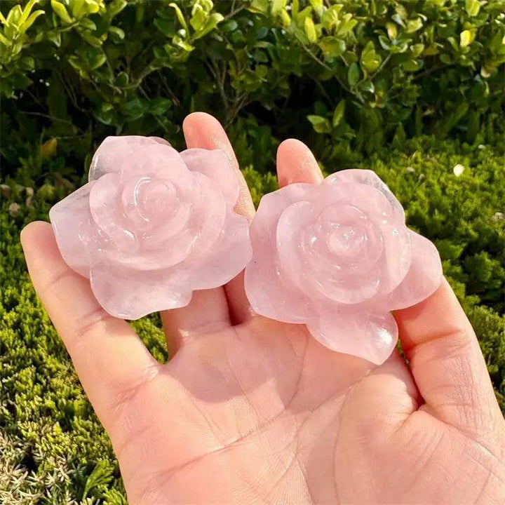 Two delicate rose quartz flower figurines, hand-carved to support the Heart Chakra with soft, blush-pink crystal energy.